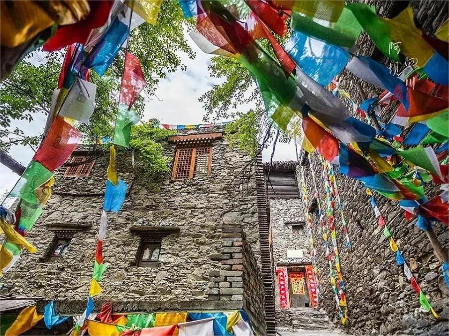 vibrant-prayer-flags-in-jiaju-tibetan-village vibrant-prayer-flags-in-jiaju-tibetan-village